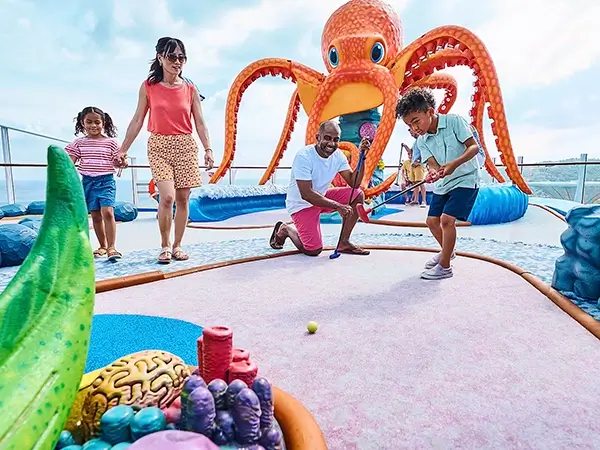 Family playing deck golf on a RCI ship