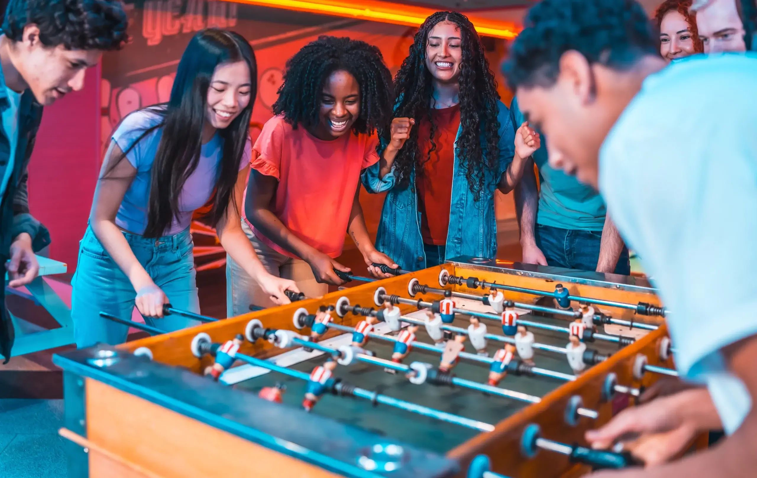Teenagers having fun playing table football